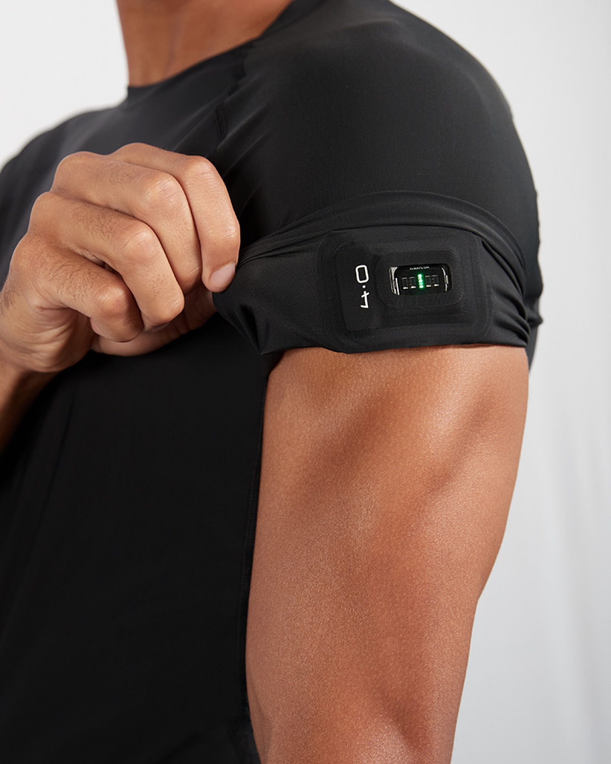 Person wearing WHOOP Body compression shirt with integrated sensor sleeve on upper arm